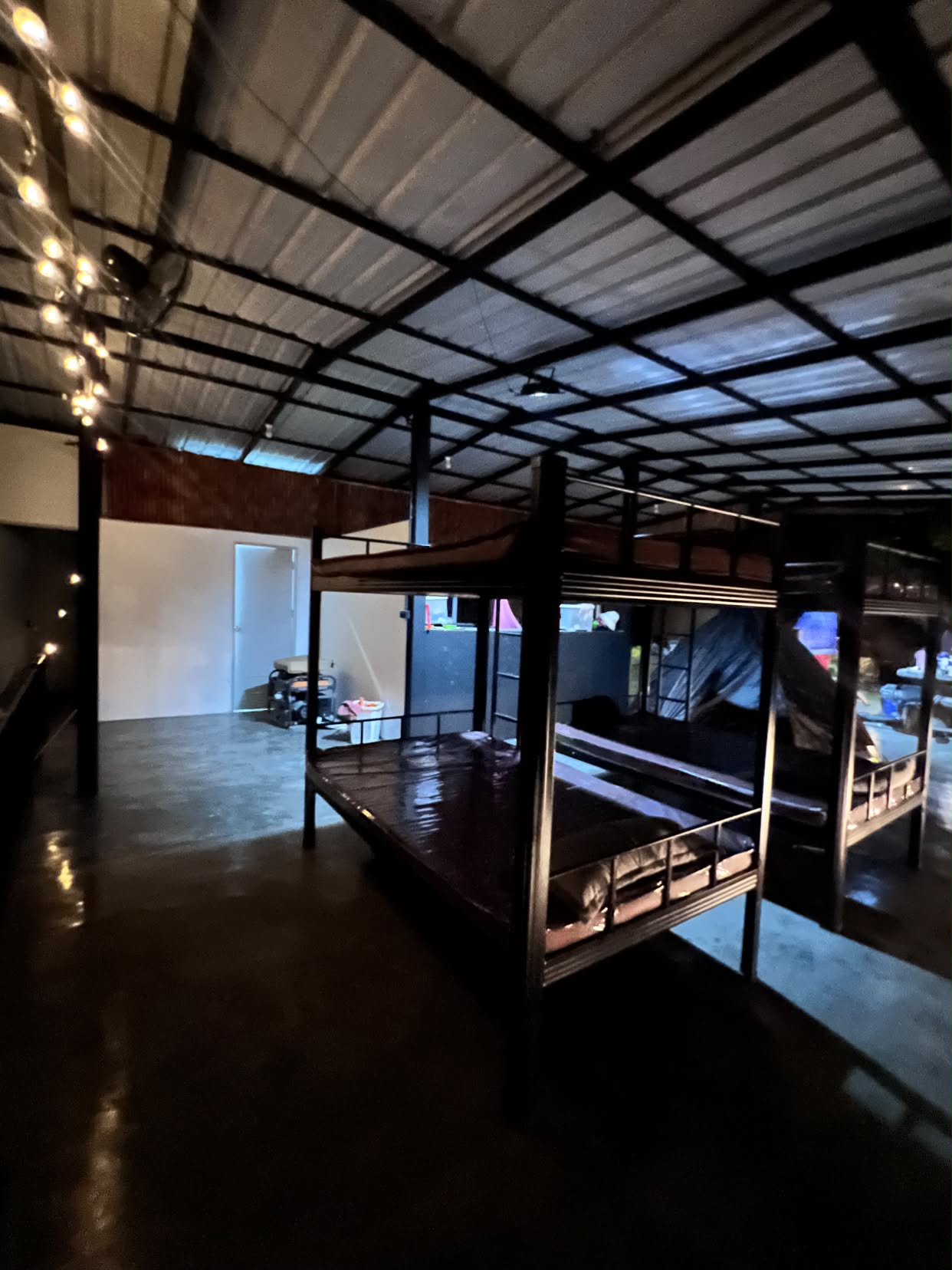 String-lit bunk beds under the metal roof at night